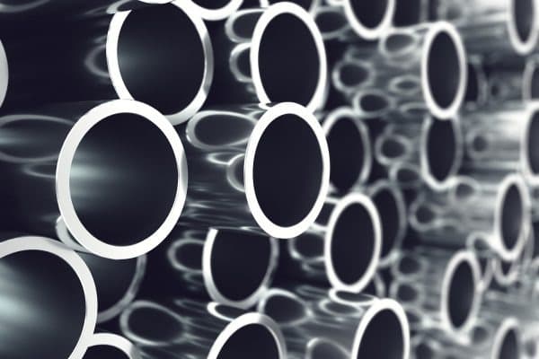 haufen von glaenzenden metallstahlrohren auf Lager
